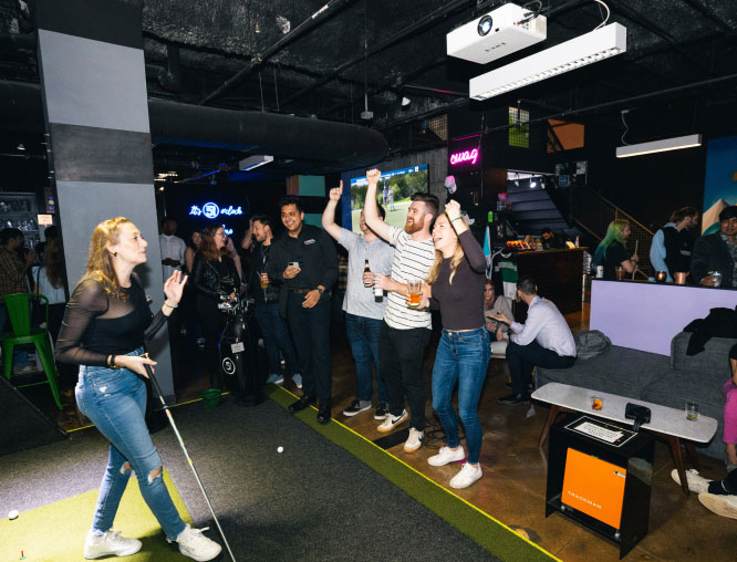 Group of friends enjoying golfing at Five Iron Golf