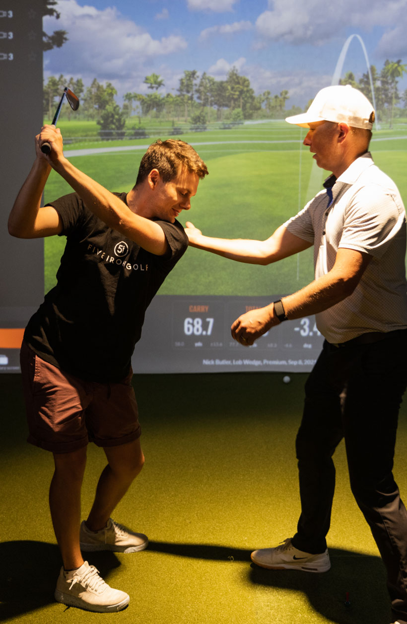 Person taking golf lessons at a Five Iron Golf location