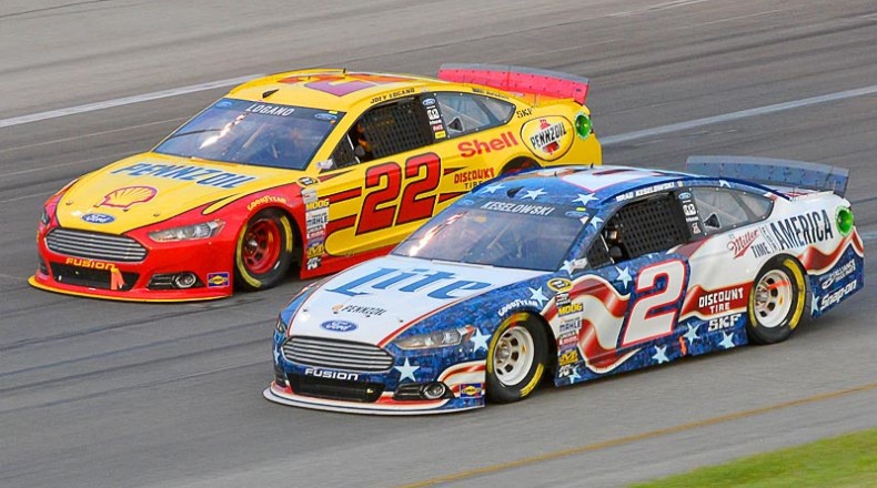 Team Penske teammates Brad Keselowski (2) and Joey Logano (22) battle for position. Photo via athlonsports.com