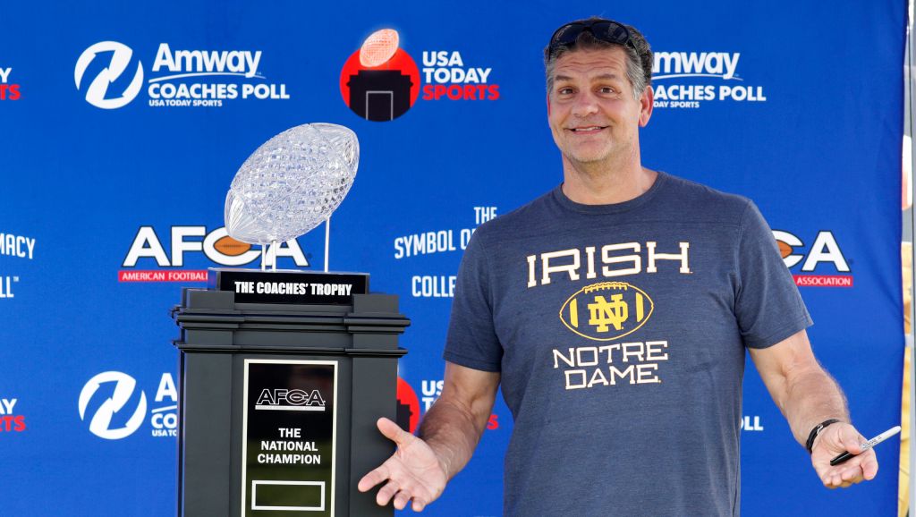 golic_sr_standing_by_trophy