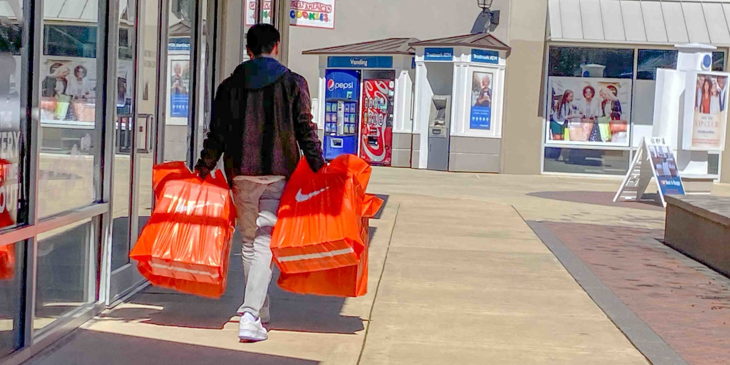 person_holding_nike_bags