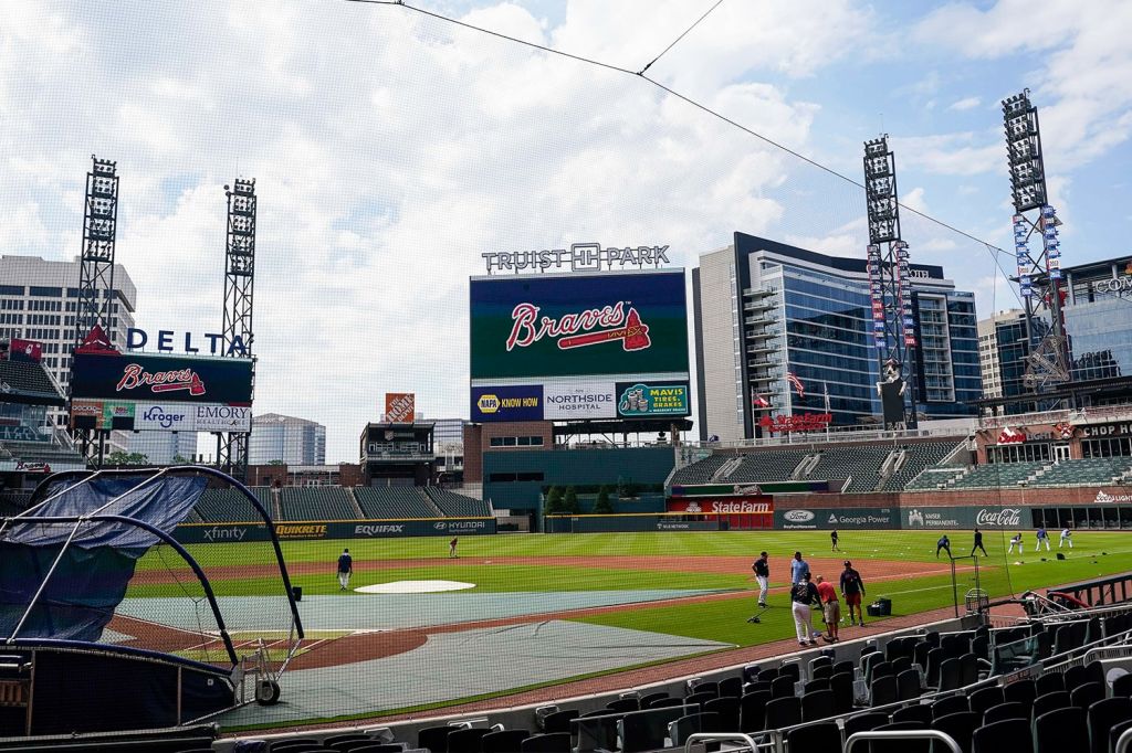 Players warm up on field inside of Atlanta Braves' Truist Park