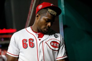 Cincinatti Reds outfielder Yasiel Puig looks dejected in team dugout