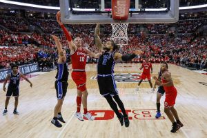 Ohio State guard attempts contested lay-up against two Duke players in mens college basketball game at Ohio State