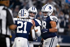 Dallas Cowboys quarterback Dak Prescott hugs running back Ezekiel Elliot during NFL game