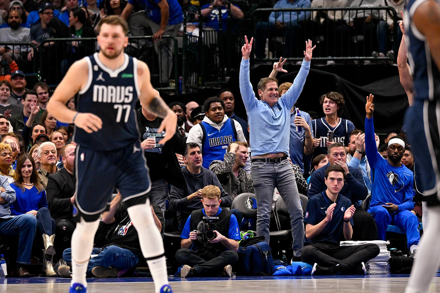 Dallas Mavericks owner Mark Cuban celebrates court side behind Luka Doncic