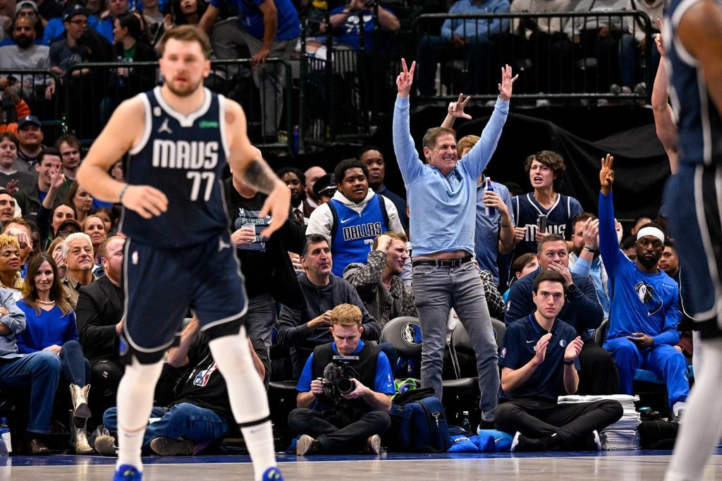 Dallas Mavericks owner Mark Cuban celebrates court side behind Luka Doncic