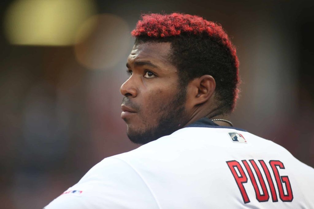 Baseball player Yasiel Puig looks over shoulder in dug-out