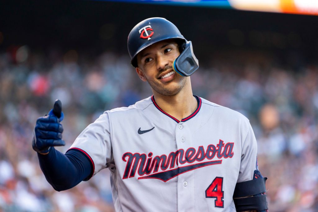 Minnesota Twins shortstop Carlos Correa shows a thumbs-up to bench