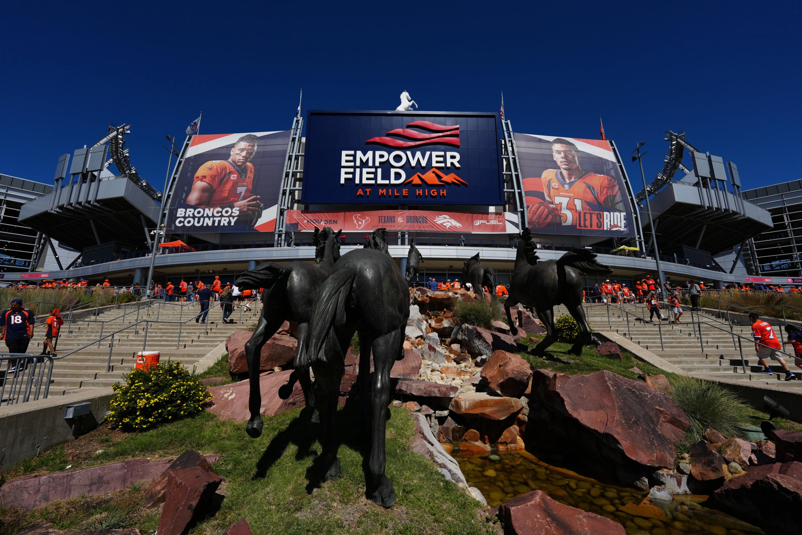 Russel Wilson "Broncos Country Lets Ride!" banners hang on side of Empower Field at Mile High in Denver