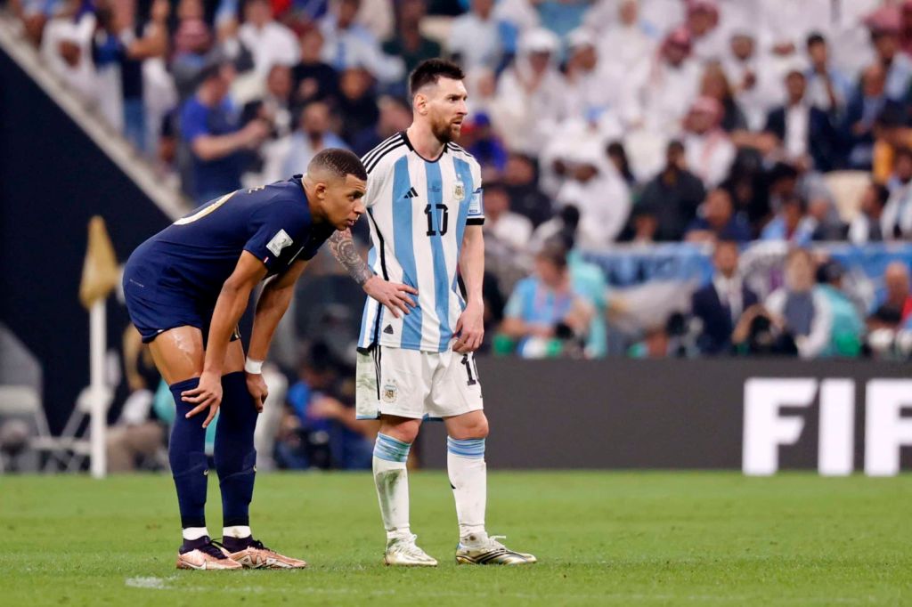 Lionel Messi and Kylian Mbappe stand side by side during World Cup final