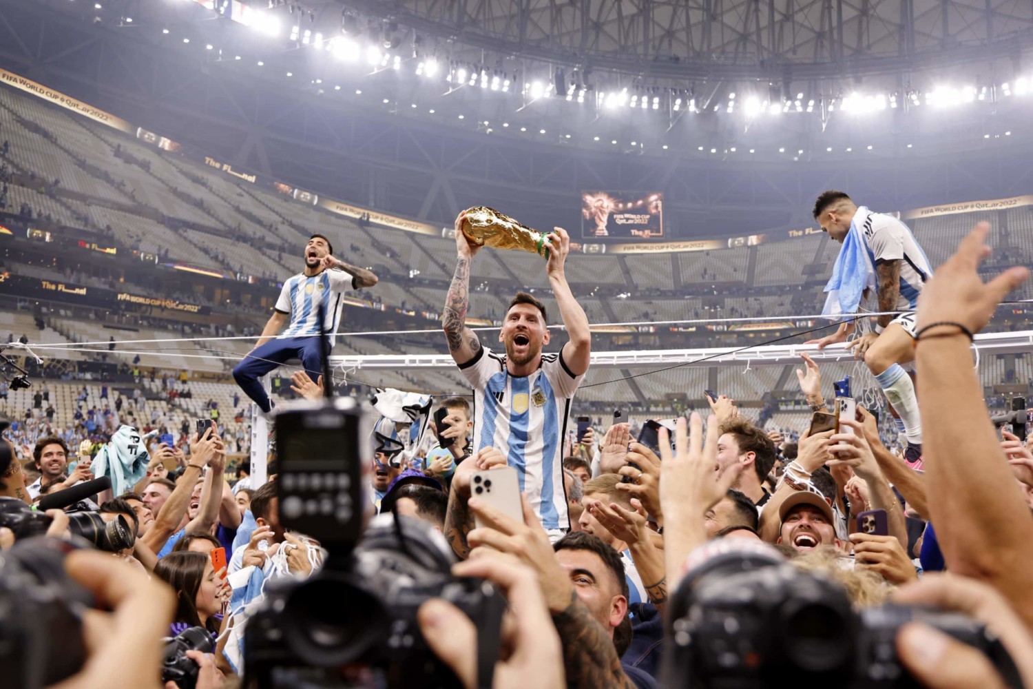 Lionel Messi hoists World Cup trophy in front of fans at Lusail Stadium in Qatar