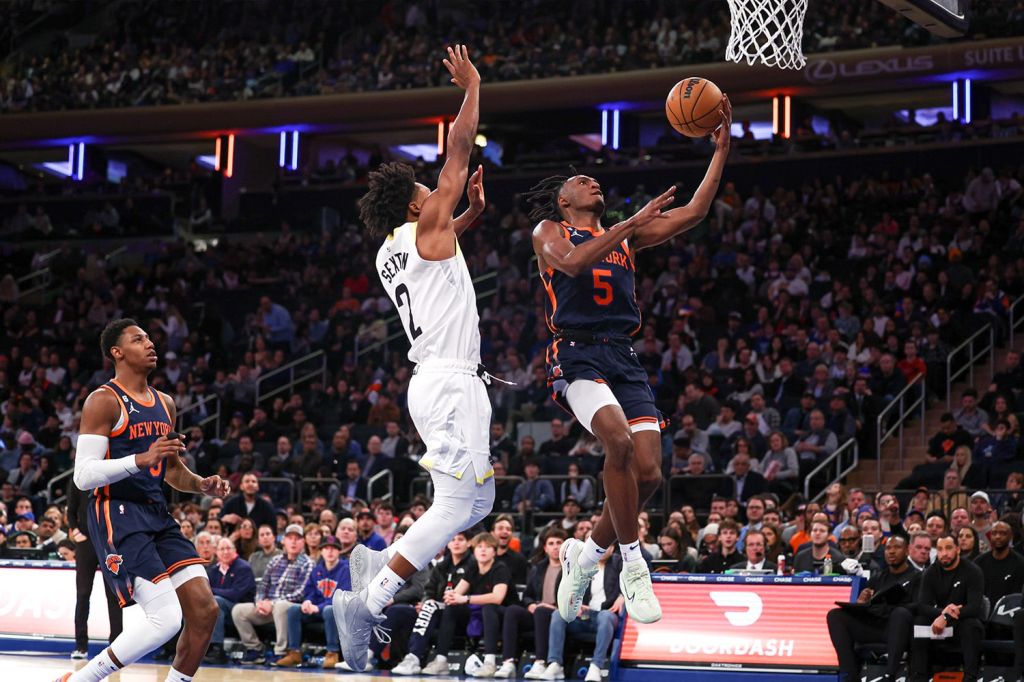 Immanuel Quickley of the New York Knicks goes for a layup during an NBA game.