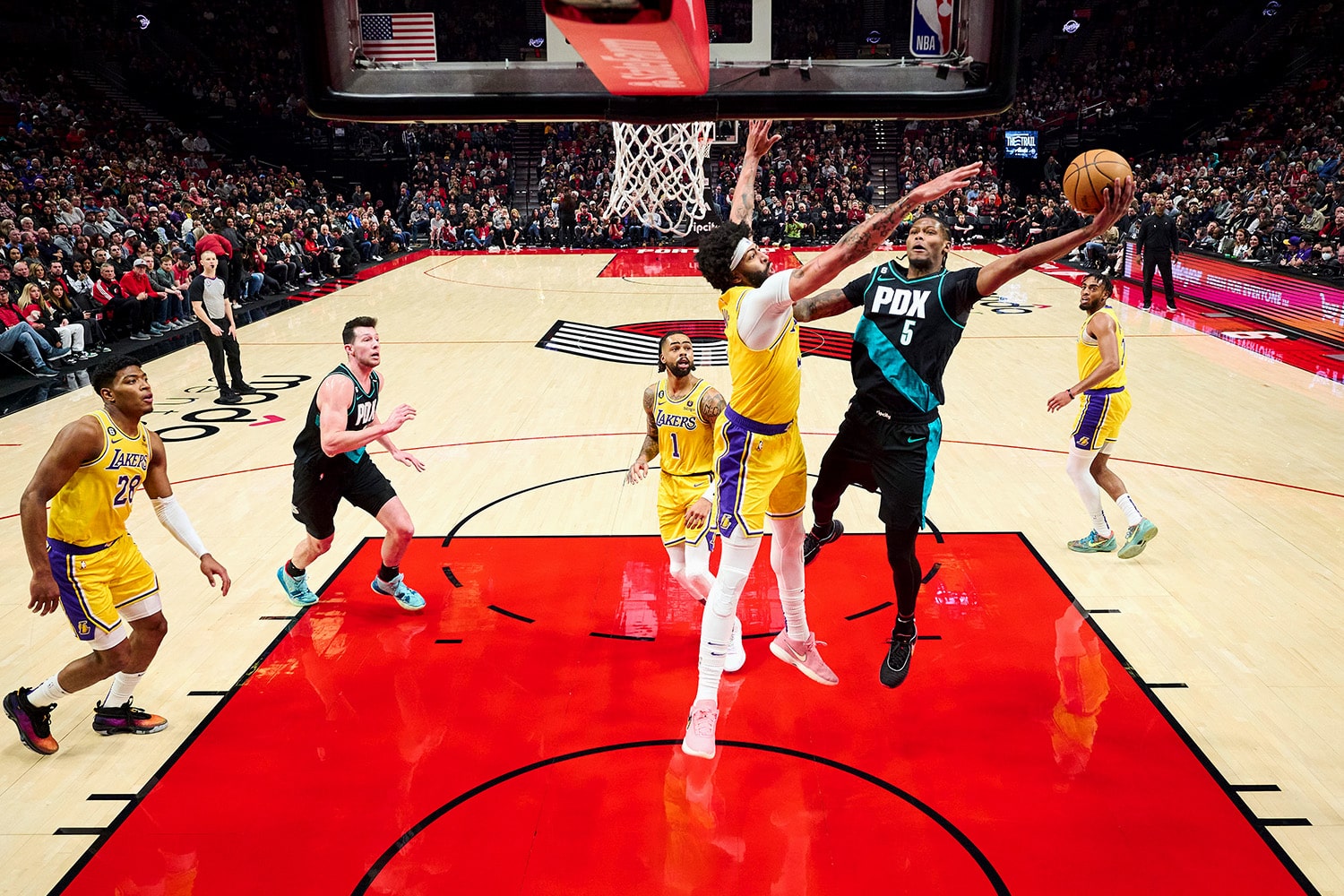 Portland Trail Blazers forward Cam Reddish drives to the basket during an NBA game against Los Angeles Lakers forward Anthony Davis.