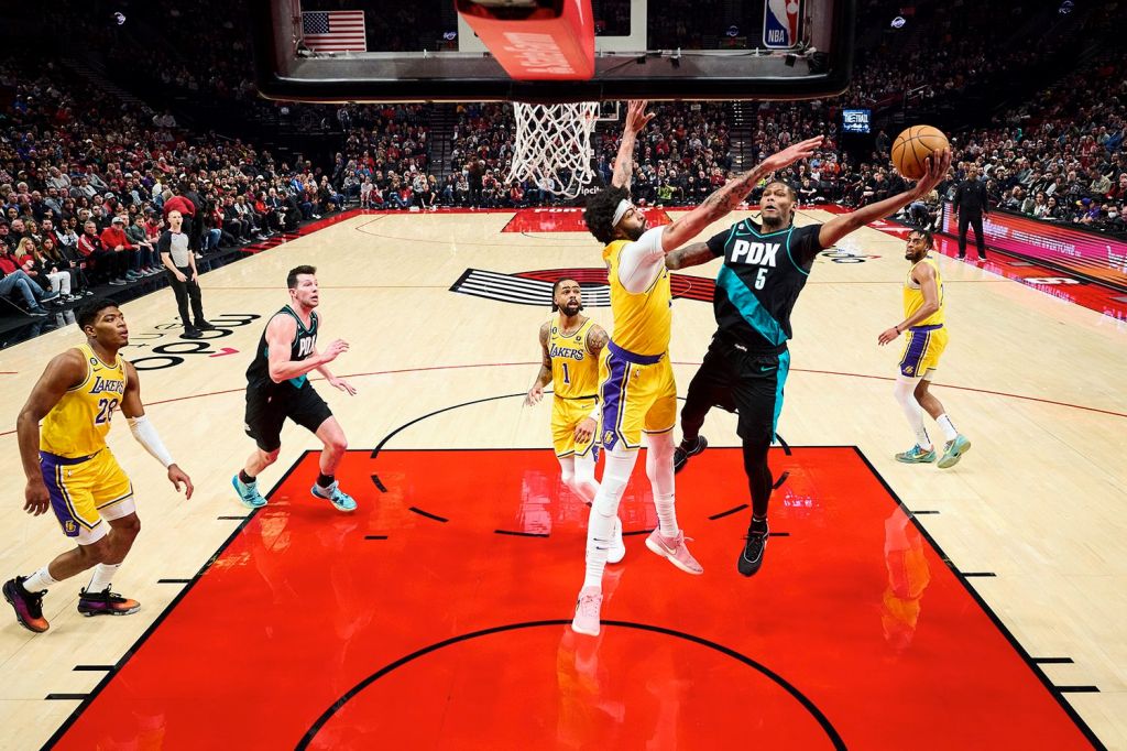 Portland Trail Blazers forward Cam Reddish drives to the basket during an NBA game against Los Angeles Lakers forward Anthony Davis.