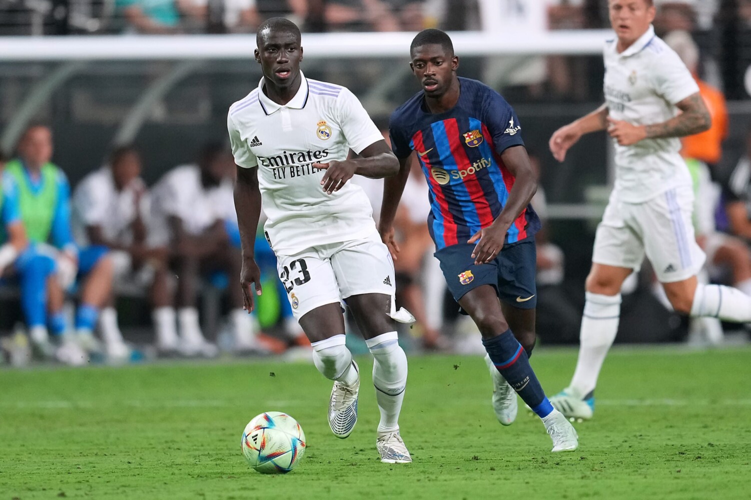 Real Madrid defender Ferland Mendy kicks the ball ahead of Barcelona forward Ousmane Dembele.