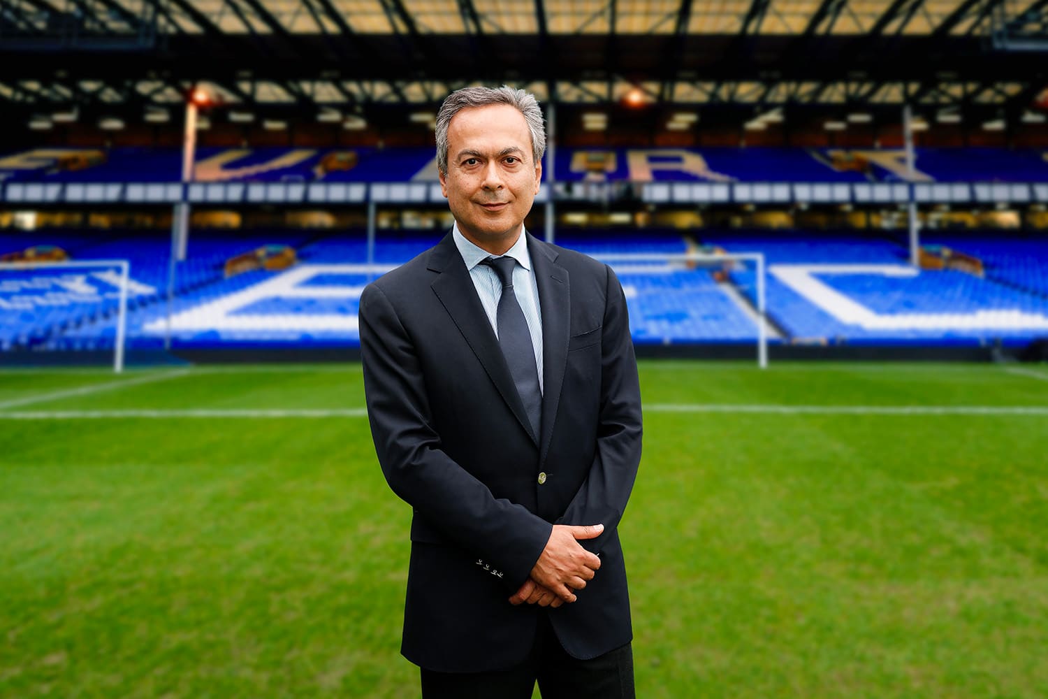 Everton FC owner Farhad Moshiri stands on the pitch at Goodison Park Stadium.