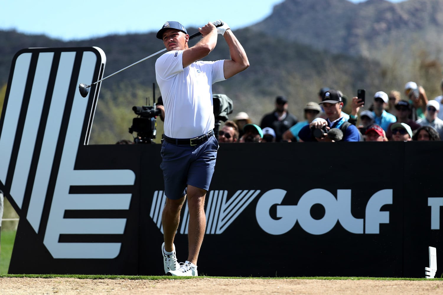 Bryson DeChambeau tees off in front of LIV Golf signage