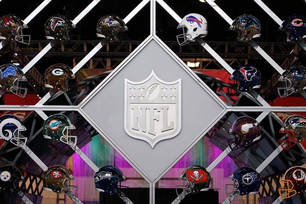 A view of the NFL logo and team helmets