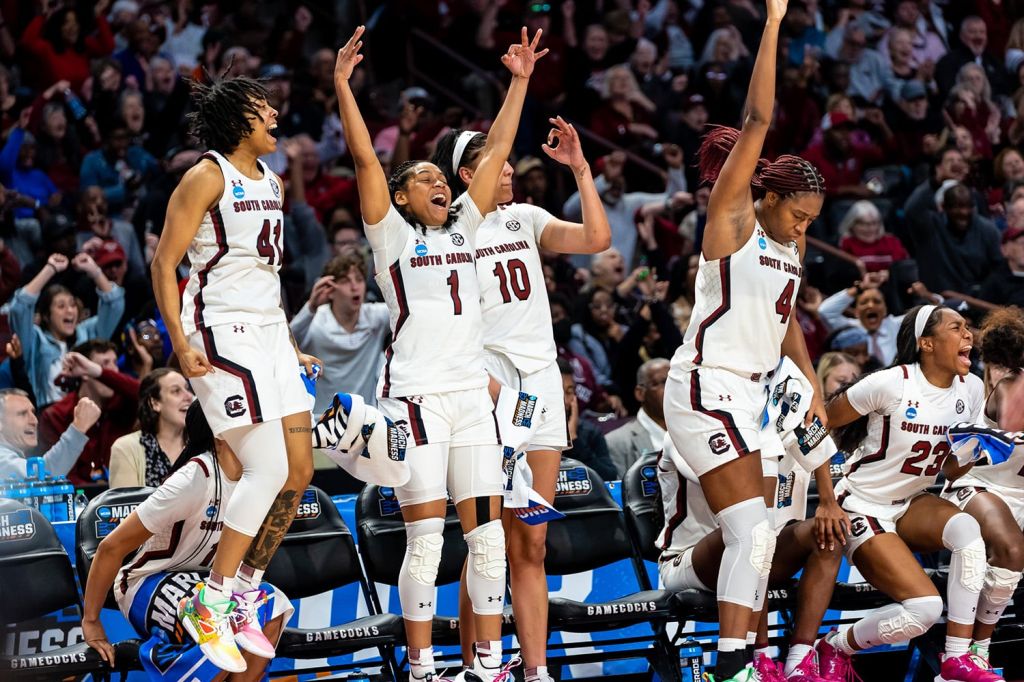 The South Carolina women's basketball team celebrates on the bench.