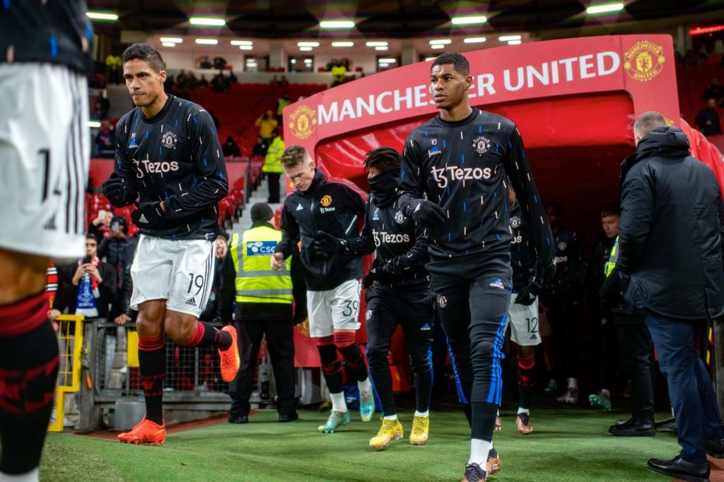 Manchester United players enter the pitch from the tunnel before a match.