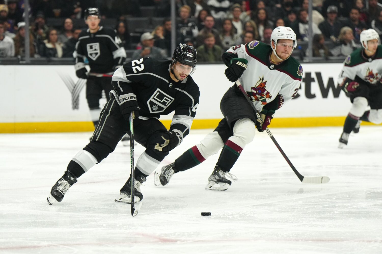 Los Angeles Kings left wing Kevin Fiala skates with the puck against Arizona Coyotes center Barrett Hayton.
