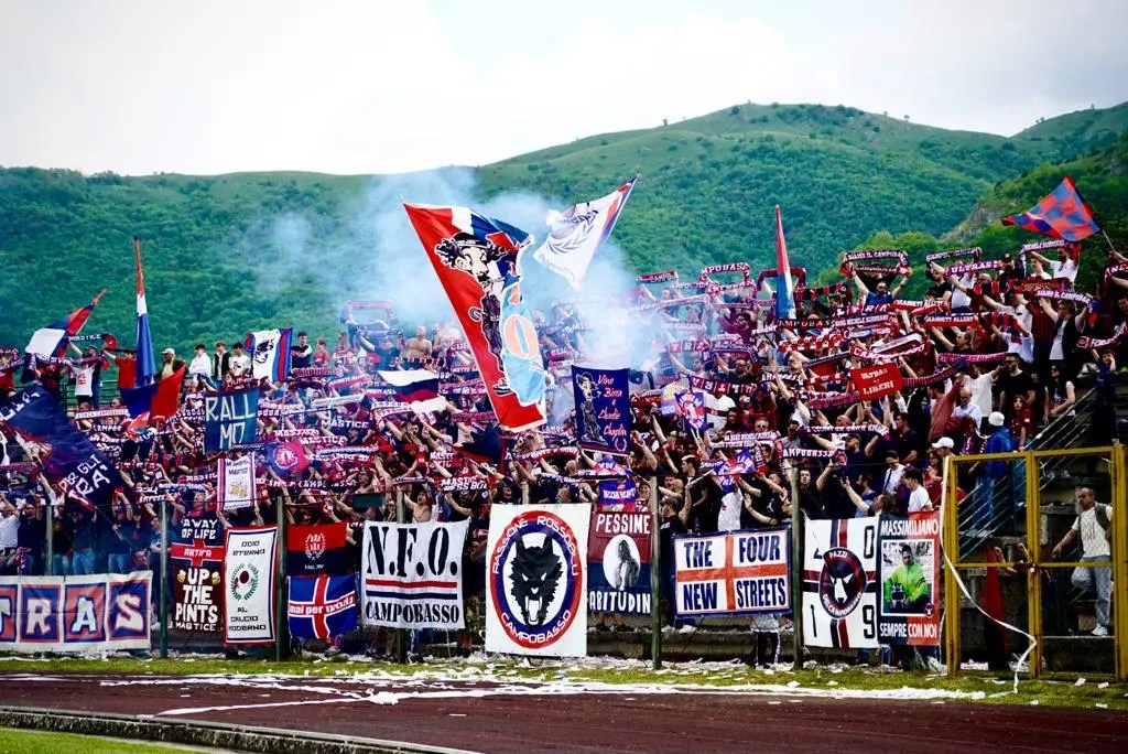 Campobasso 1919 supporters waving flags at a match.