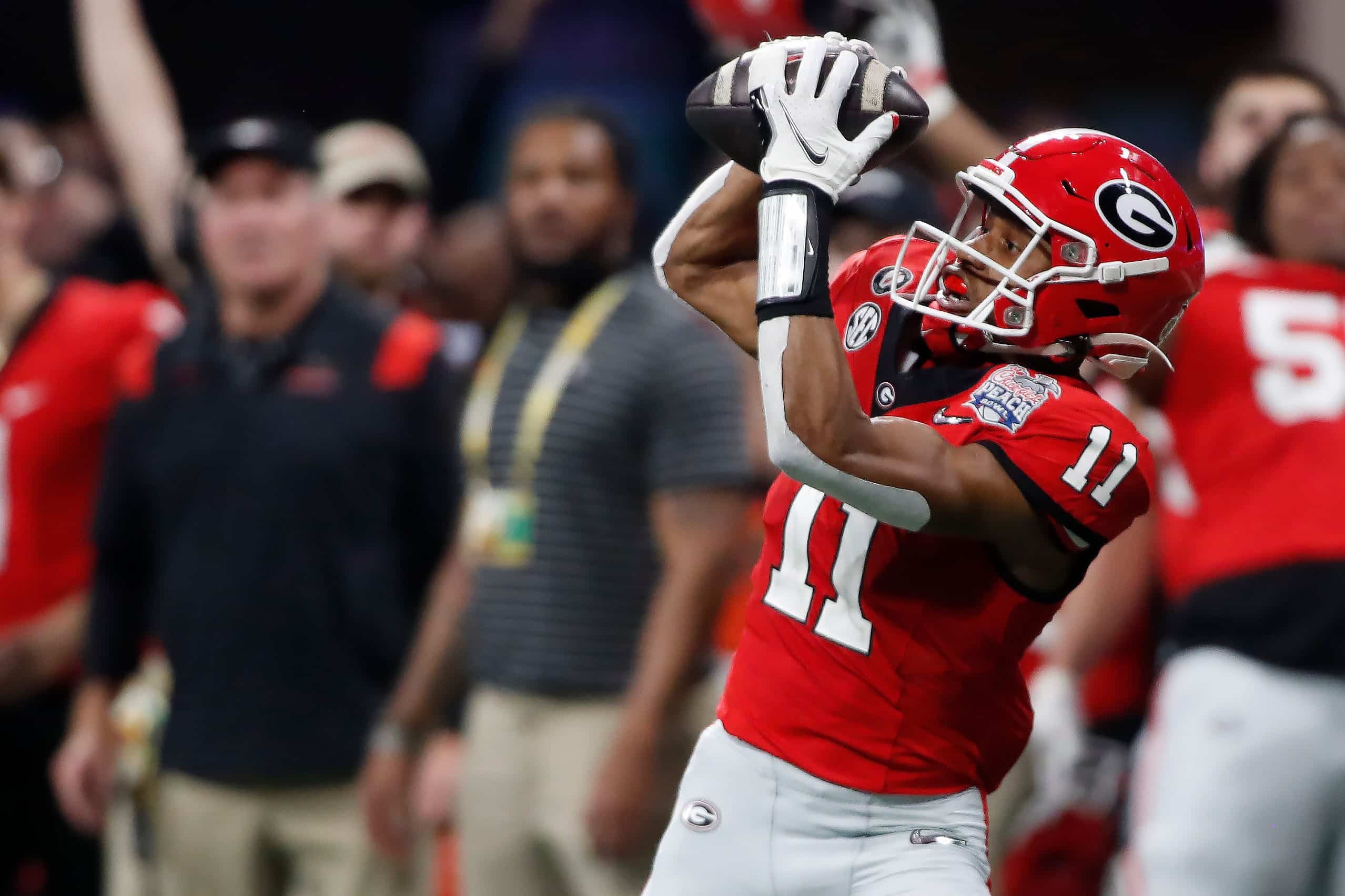 Georgia wide receiver Arian Smith (11) makes a catch off a pass from Georgia quarterback Stetson Bennett (13) during the second half of the Chick-fil-A Peach Bowl NCAA College Football Playoff semifinal game between Ohio State and Georgia on Saturday, Dec 31, 2022, in Atlanta. Georgia won 42-41.