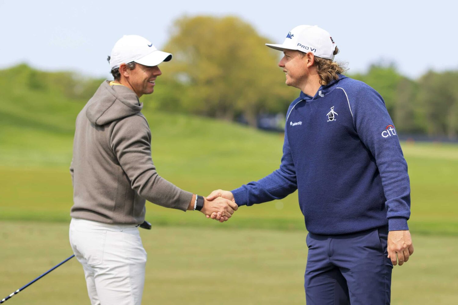 Cameron Smith shakes hands with Rory McIlroy at the driving range during a practice round of the PGA Championship in Rochester, New York.