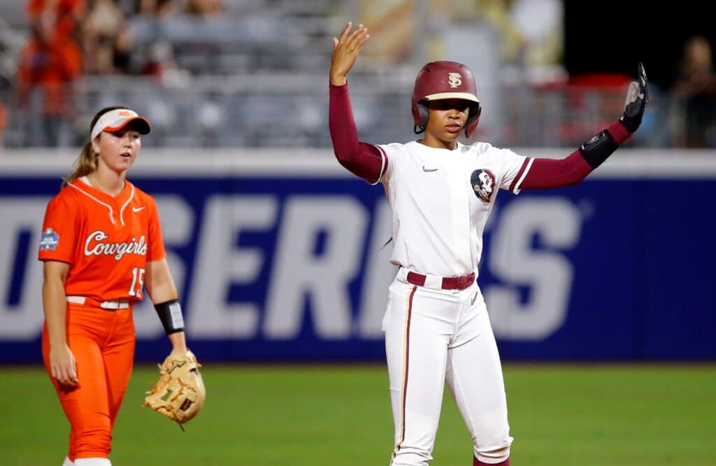 Florida State.'s Michaela Edenfield (51) celebrates a second next to Oklahoma State's Rachel Becker (15) in the third inning during a softball game between Oklahoma State Cowgirls and Florida State in the Women's College World Series at USA Softball Hall of Fame Stadium in in Oklahoma City, Thursday, June, 1, 2023.