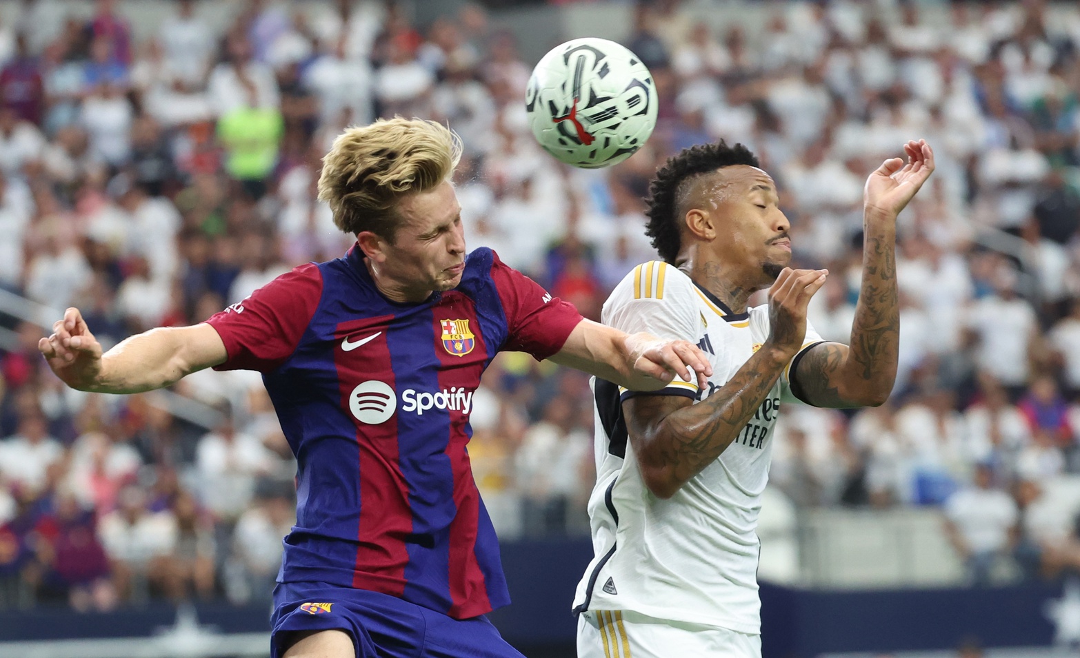 Jul 29, 2023; Arlington, Texas, USA; FC Barcelona midfielder Frenkie de Jong (21) and Real Madrid defender Eder Militao (3) battle for the ball during the first half at AT&T Stadium. Mandatory Credit: Kevin Jairaj-USA TODAY Sports