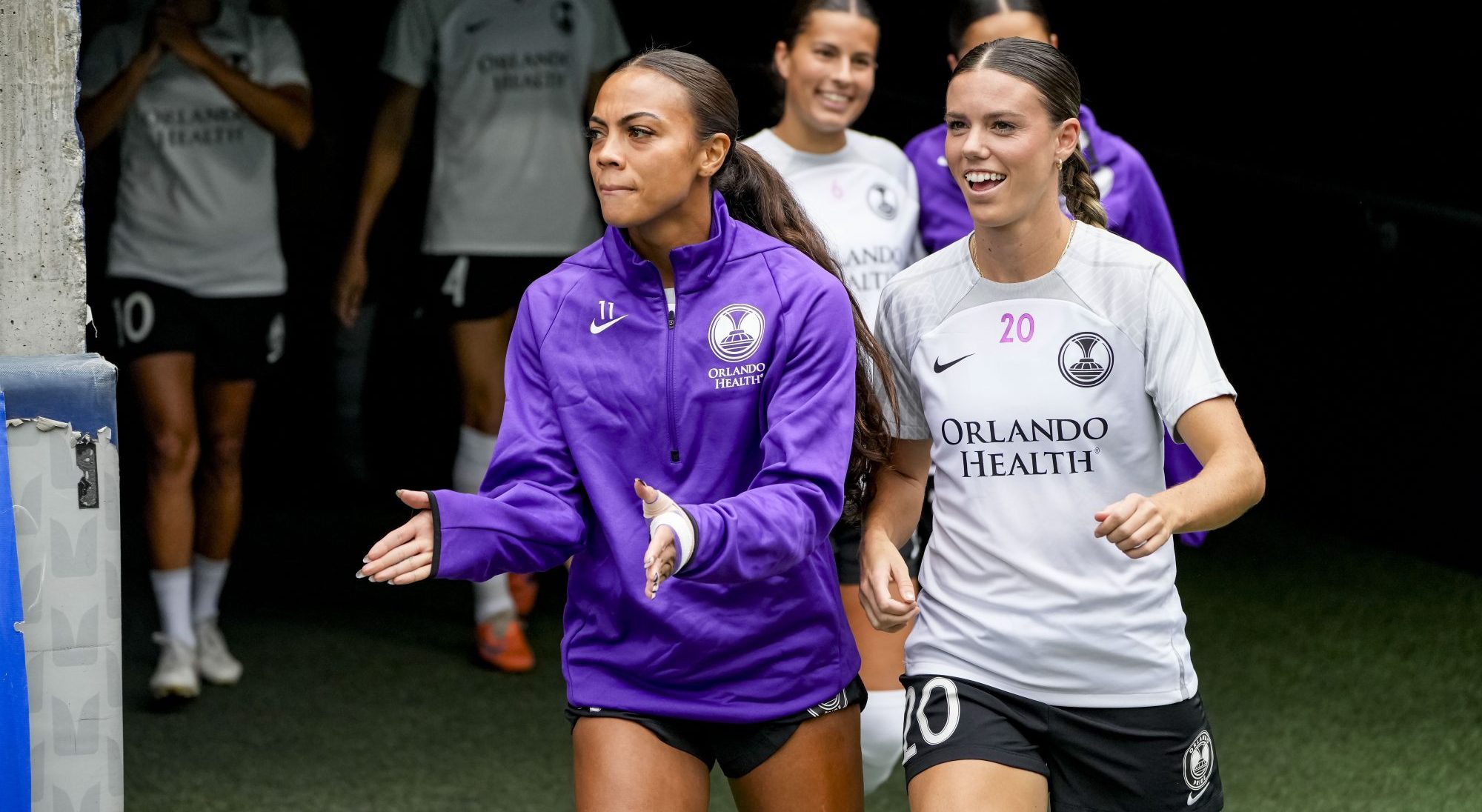 Sep 3, 2023; Seattle, Washington, USA; Orlando Pride forward Ally Watt (11) and Orlando Pride forward Julie Doyle (20) enter the stadium before the game against OL Reign at Lumen Field.