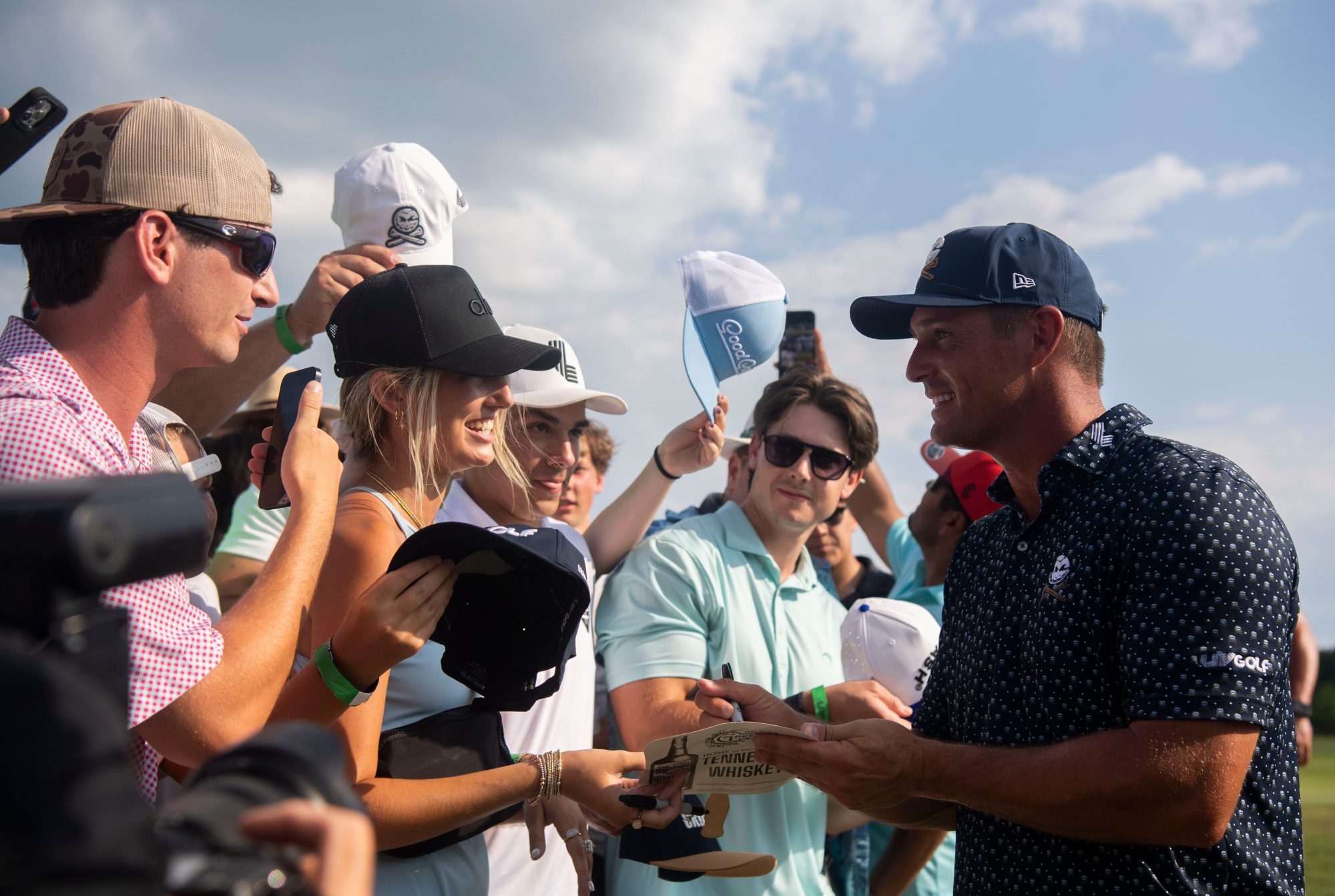 Bryson DeChambeau signs autographs after the first day of the LIV Golf Tournament at The Grove near Franklin, Tenn., Friday, June 21, 2024.
