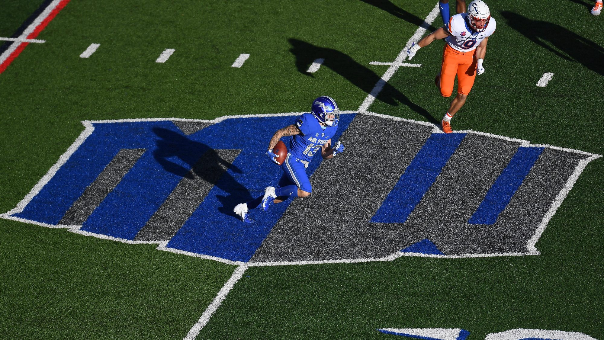 Oct 31, 2020; Colorado Springs, Colorado, USA; Air Force Falcons wide receiver Brandon Lewis (13) carries the ball over the Mountain West logo on the field against the Boise State Broncos in the first quarter at Falcon Stadium.