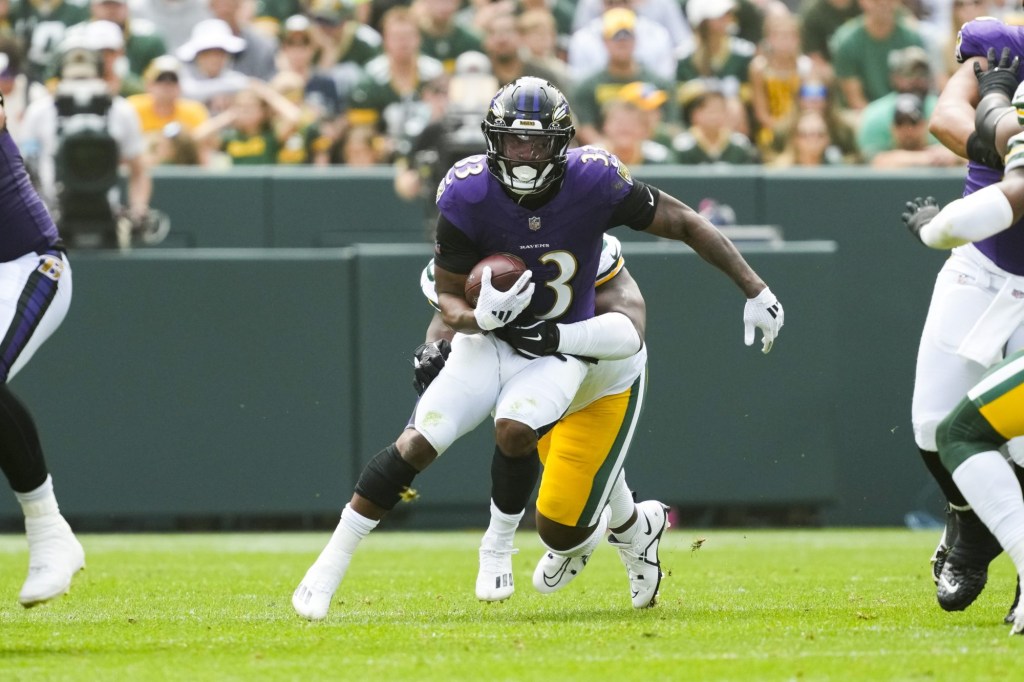 Aug 24, 2024; Green Bay, Wisconsin, USA;  Baltimore Ravens running back John Kelly (33) rushes with the football during the second quarter against the Green Bay Packers at Lambeau Field