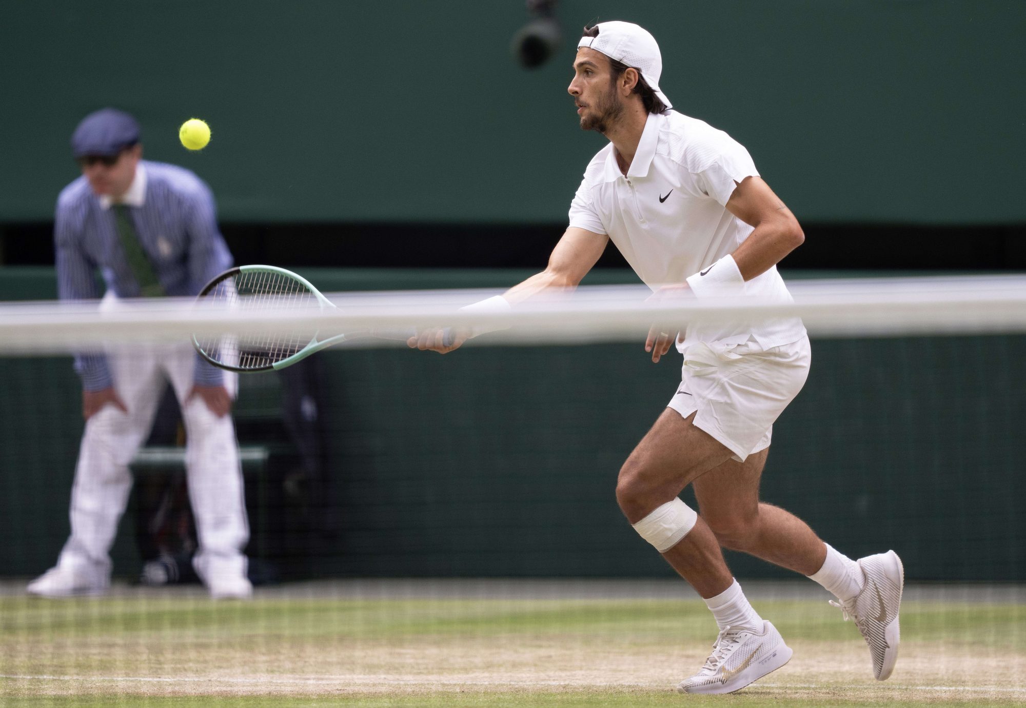 Jul 12, 2024; London, United Kingdom; Lorenzo Musetti of Italy returns a shot against Novak Djokovic of Serbia on day 12 at All England Lawn Tennis and Croquet Club.