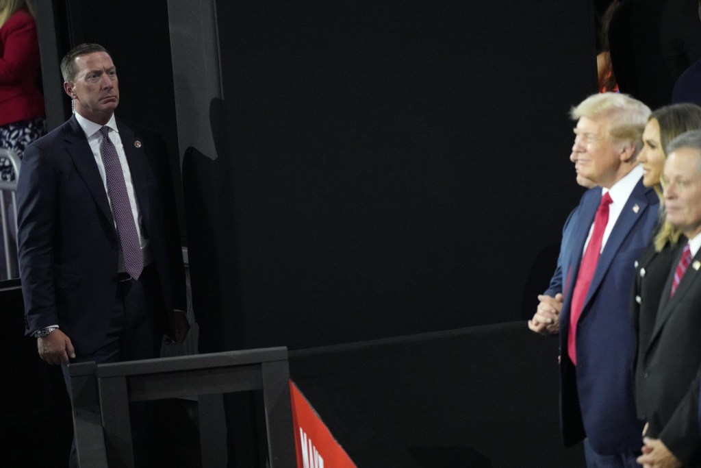 July 18, 2024; Milwaukee, WI, USA; A Secret Service agent watches over Donald Trump during the final day of the Republican National Convention at the Fiserv Forum. The final day of the RNC featured a keynote address by Republican presidential nominee Donald Trump.