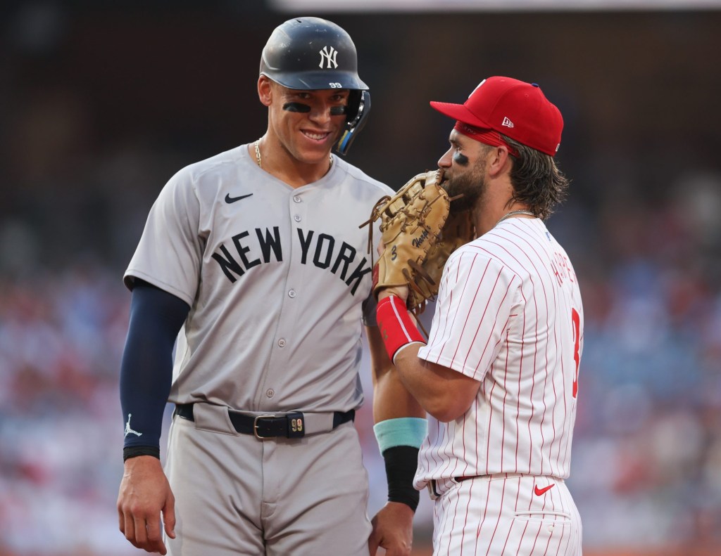 Jul 30, 2024; Philadelphia, Pennsylvania, USA; New York Yankees outfielder Aaron Judge (99) with Philadelphia Phillies first base Bryce Harper (3) on first base after his single during the first inning at Citizens Bank Park.