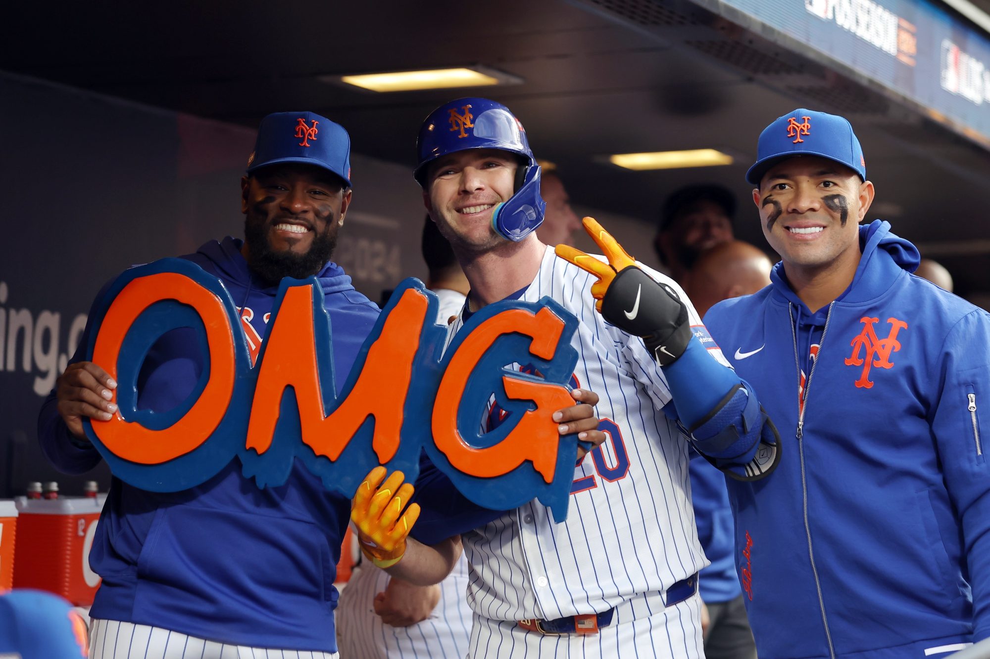 Oct 8, 2024; New York City, New York, USA; New York Mets first baseman Pete Alonso (20) celebrates in the dugout after hitting a solo home run with New York Mets pitcher Luis Severino (left) and pitcher Jose Quintana (right) in the second inning against the Philadelphia Phillies during game three of the NLDS for the 2024 MLB Playoffs at Citi Field.