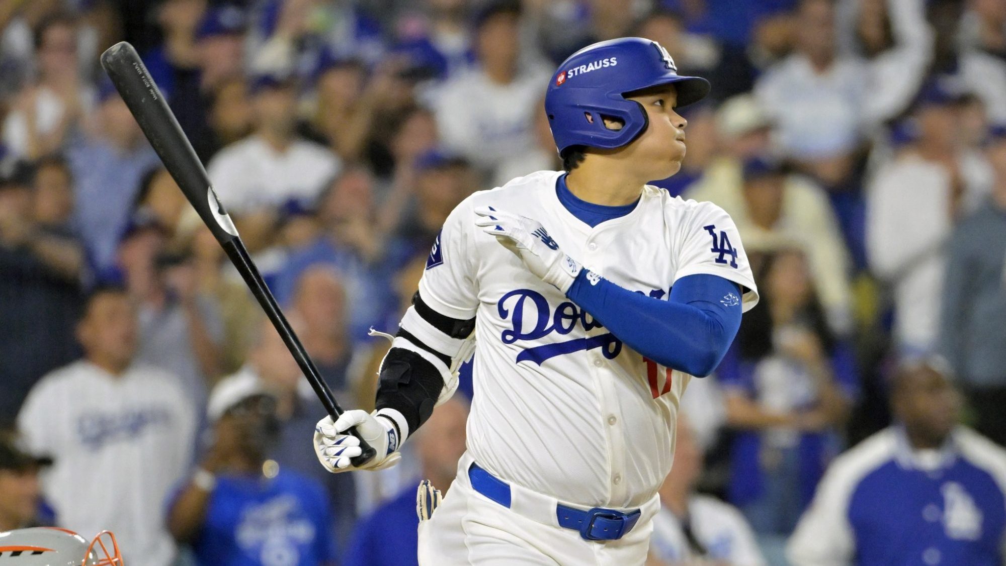 Oct 20, 2024; Los Angeles, California, USA; Los Angeles Dodgers designated hitter Shohei Ohtani (17) hits an RBI single in the sixth inning against the New York Mets during game six of the NLCS for the 2024 MLB playoffs at Dodger Stadium.