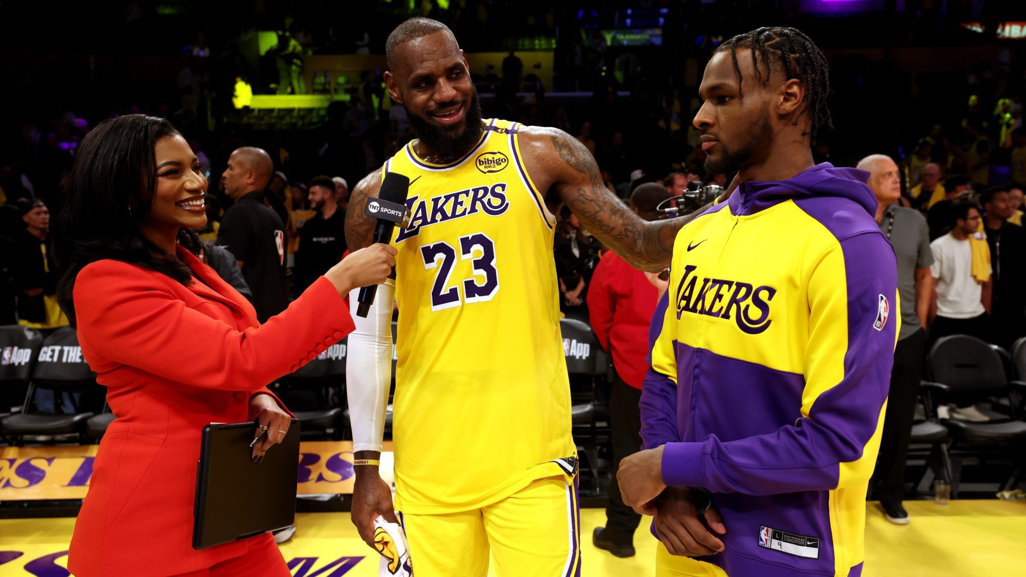 Oct 22, 2024; Los Angeles, California, USA; NBA on TNT sideline reporter Taylor Rooks interviews Los Angeles Lakers forward LeBron James (23) and guard Bronny James (9) after they defeated the Minnesota Timberwolves at Crypto.com Arena.