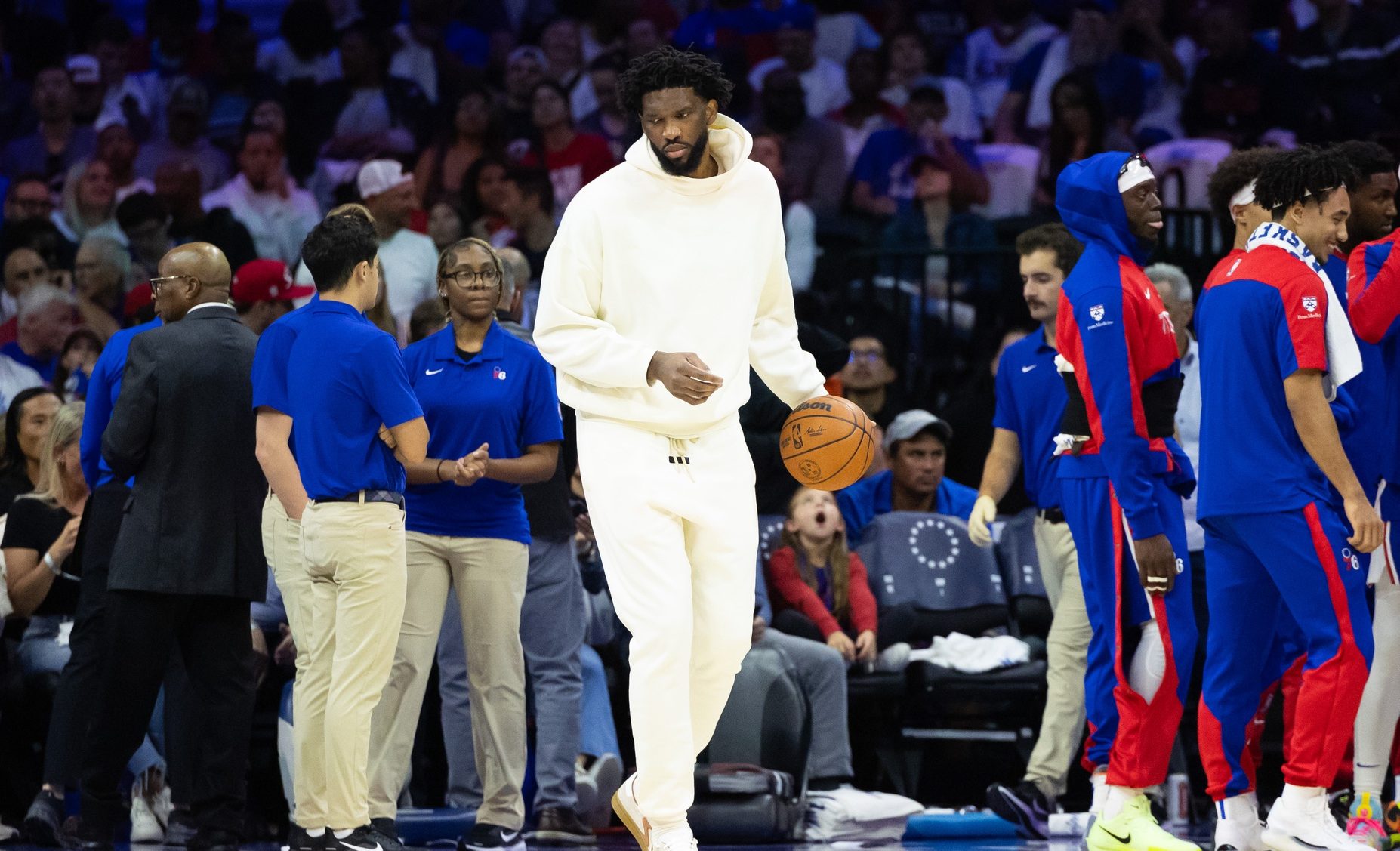 Oct 23, 2024; Philadelphia, Pennsylvania, USA; Philadelphia 76ers center Joel Embiid in plain clothes dribbles the ball during a timeout in the second quarter against the Milwaukee Bucks at Wells Fargo Center.