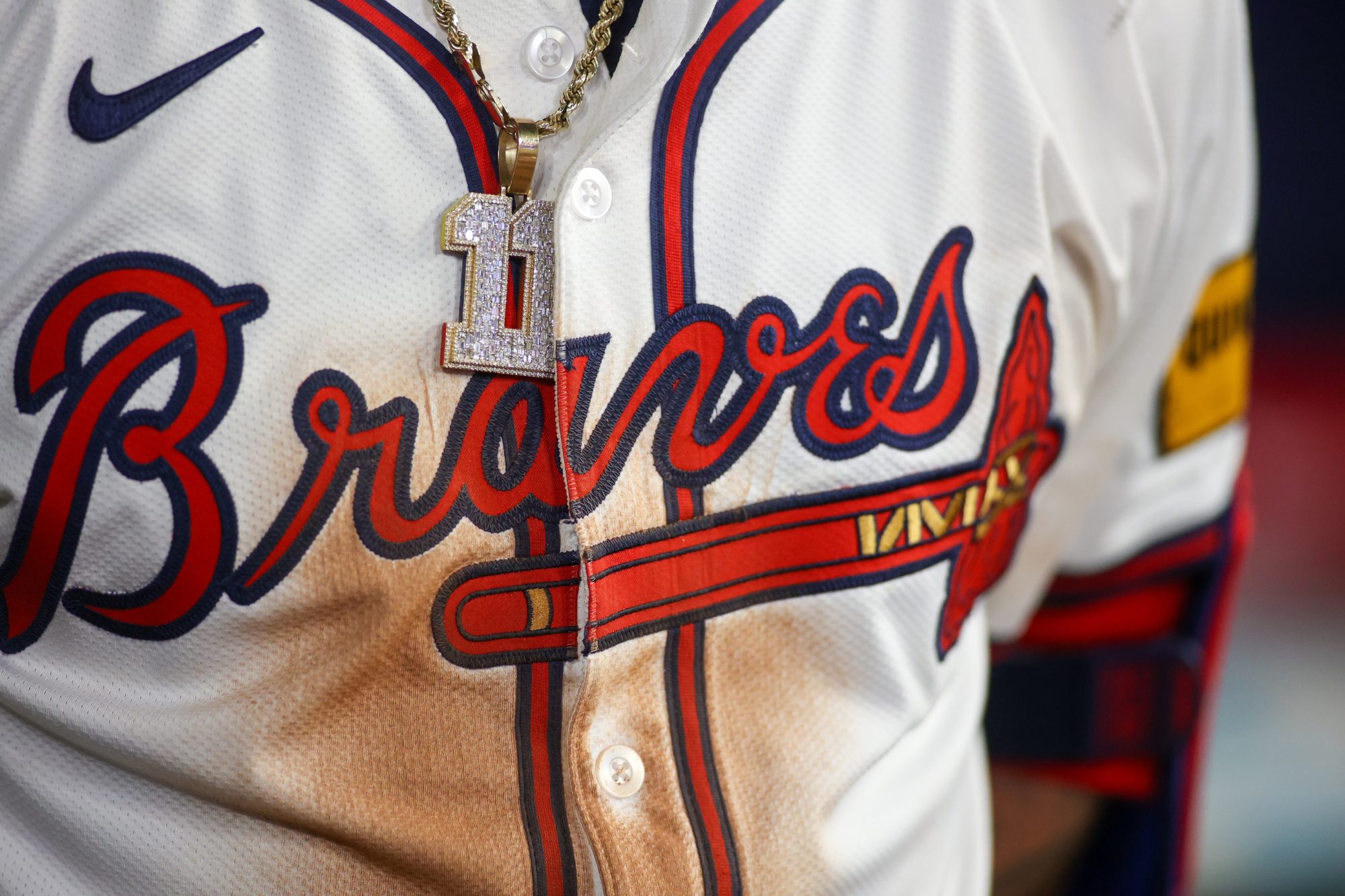 May 19, 2024; Atlanta, Georgia, USA; A detailed view of the chain and jersey of Atlanta Braves shortstop Orlando Arcia (11) against the San Diego Padres in the seventh inning at Truist Park.