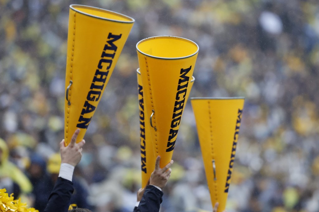 Sep 28, 2024; Ann Arbor, Michigan, USA; Michigan Wolverines cheerleader hold up megaphone in the first half against the Minnesota Golden Gophers at Michigan Stadium.