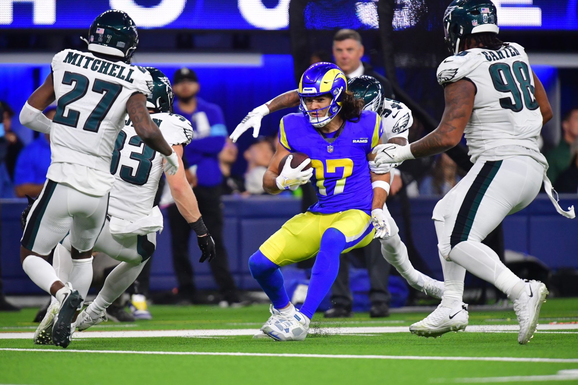 Nov 24, 2024; Inglewood, California, USA; Los Angeles Rams wide receiver Puka Nacua (17) runs the ball against Philadelphia Eagles cornerback Cooper DeJean (33) cornerback Quinyon Mitchell (27) and defensive tackle Jalen Carter (98) during the second half at SoFi Stadium.