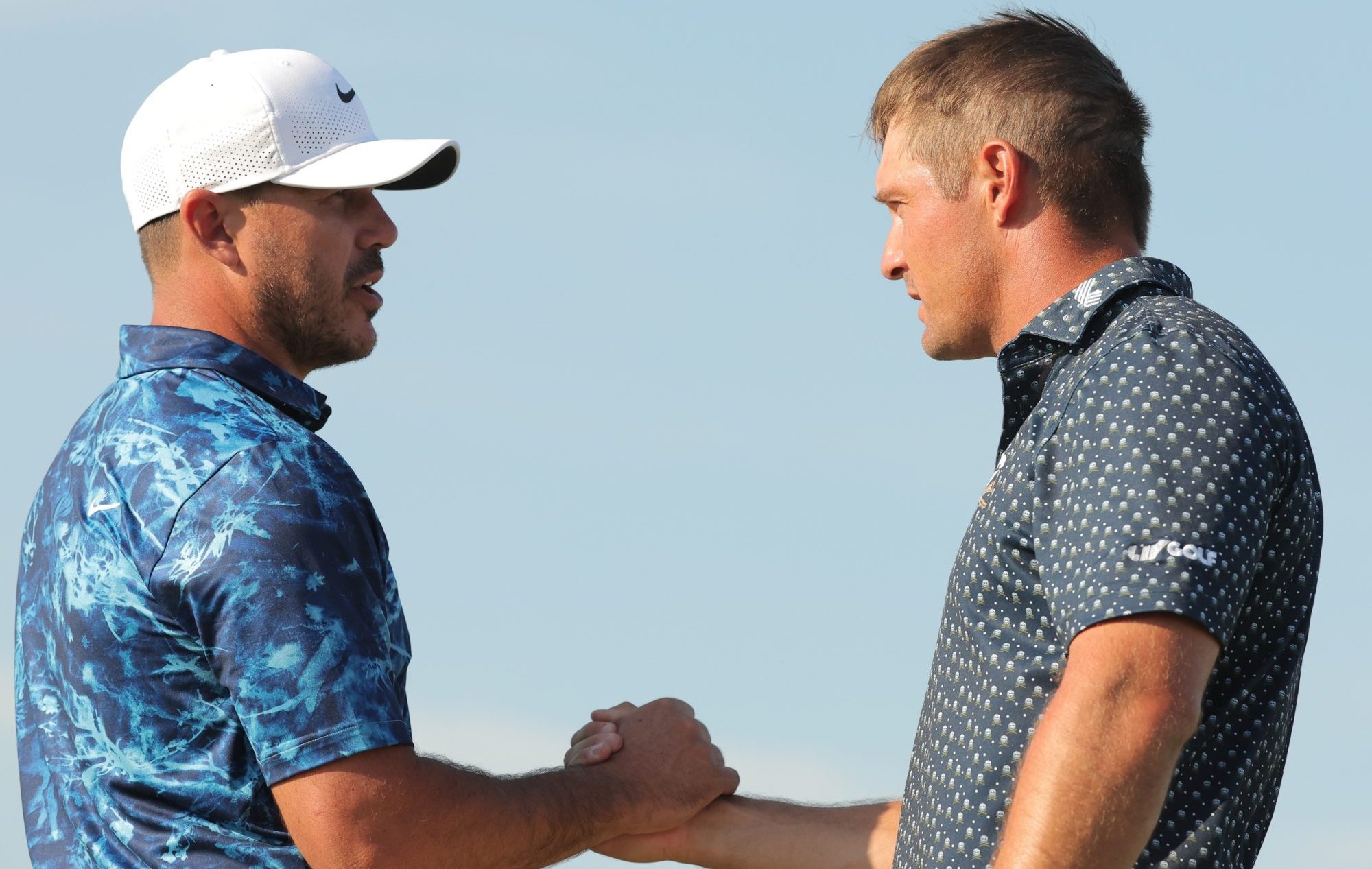 Sep 13, 2024; Bolingbrook, Illinois, USA; (Editors Notes: Caption Correction) Bryson DeChambeau of the Crushers GC and Brooks Koepka of the Smash GC shake hands after the first round of the LIV Golf Chicago tournament at Bolingbrook Golf Club.