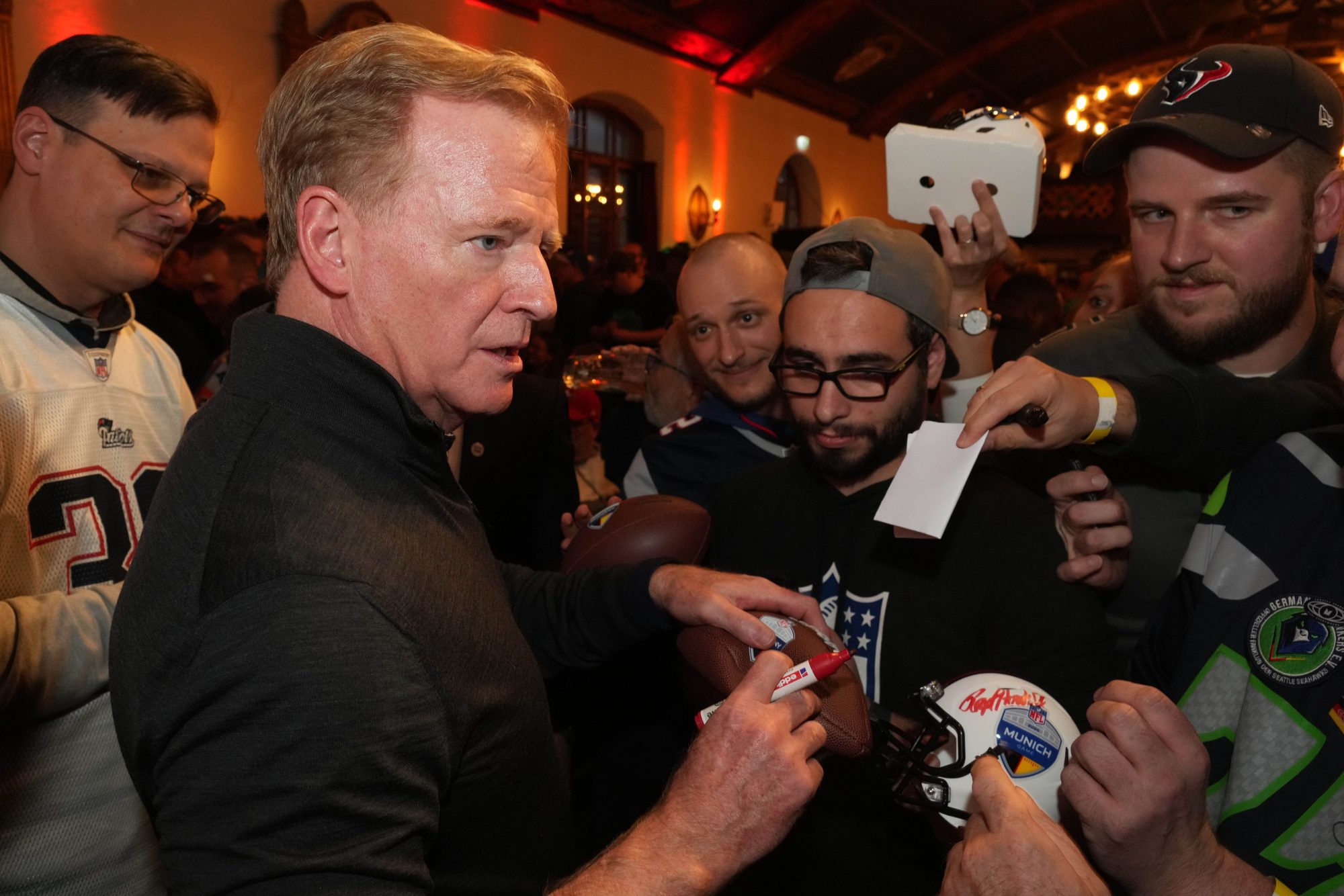 Nov 9, 2024; Munich, Germany; NFL commissioner Roger Goodell signs autographs during NFL Live Munich at Augustiner-Keller.