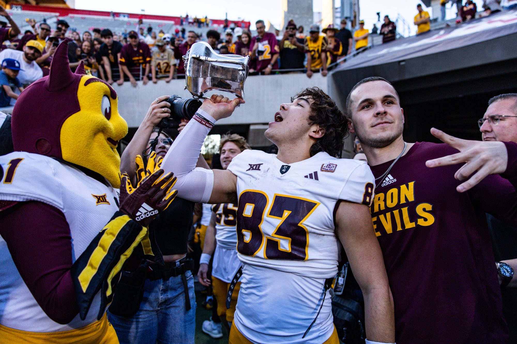 Nov 30, 2024; Tucson, Arizona, USA; Arizona State Sun Devils wide receiver Derek Eusebio (83) drinks out of the Territorial Cup at the end of the game against the Arizona Wildcats at Arizona Stadium.