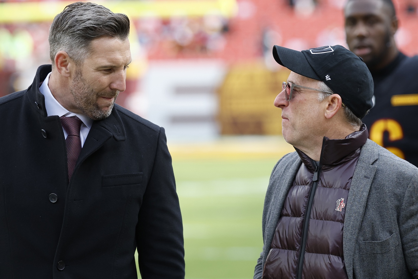 Dec 1, 2024; Landover, Maryland, USA; Washington Commanders general manager Adam Peters (L) talks with Commanders owner Josh Harris (R) on the field prior to the game against the Tennessee Titans at Northwest Stadium.