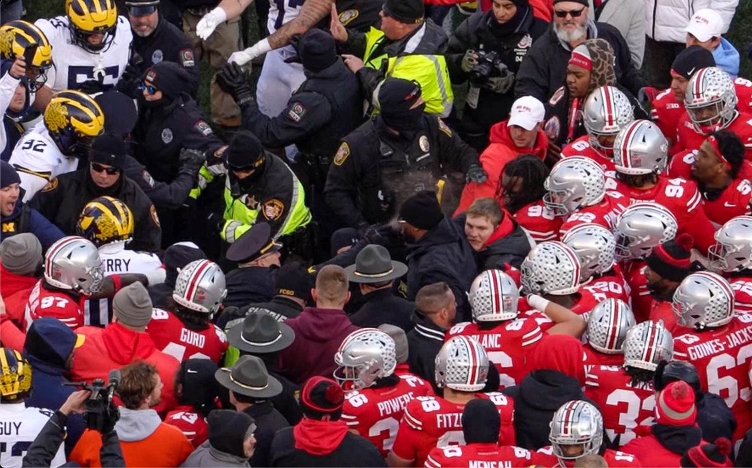 A University of Michigan police officer sprays pepper spray as Michigan Wolverines and Ohio State Buckeyes fight following the NCAA football game at Ohio Stadium in Columbus on Saturday, Nov. 30, 2024. Michigan won 13-10.